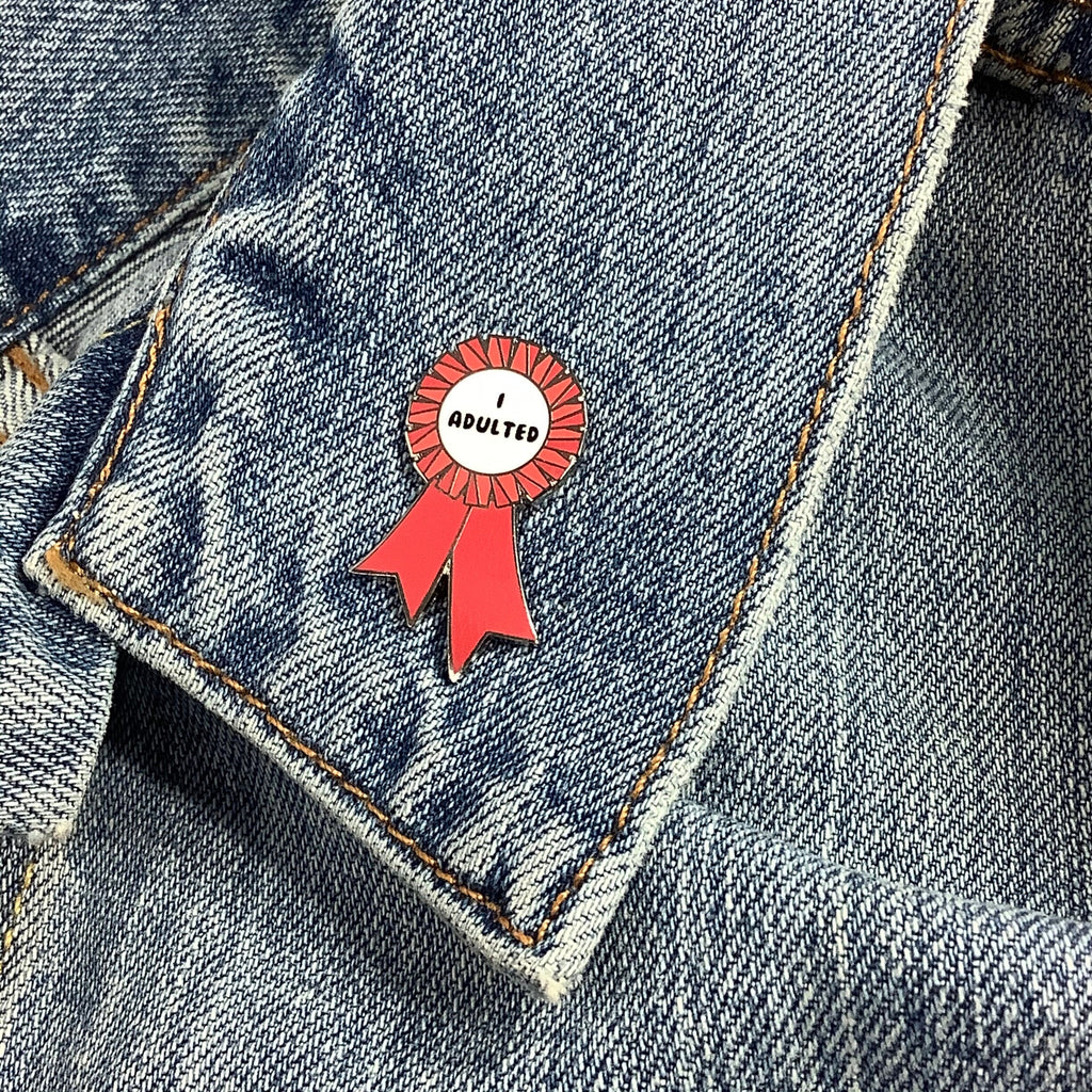Red I ADULTED award ribbon enamel pin